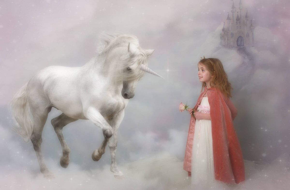 Girl posing with a unicorn during the Mermaids and Unicorns fantasy photoshoot at Oakley Studios, Bedfordshire