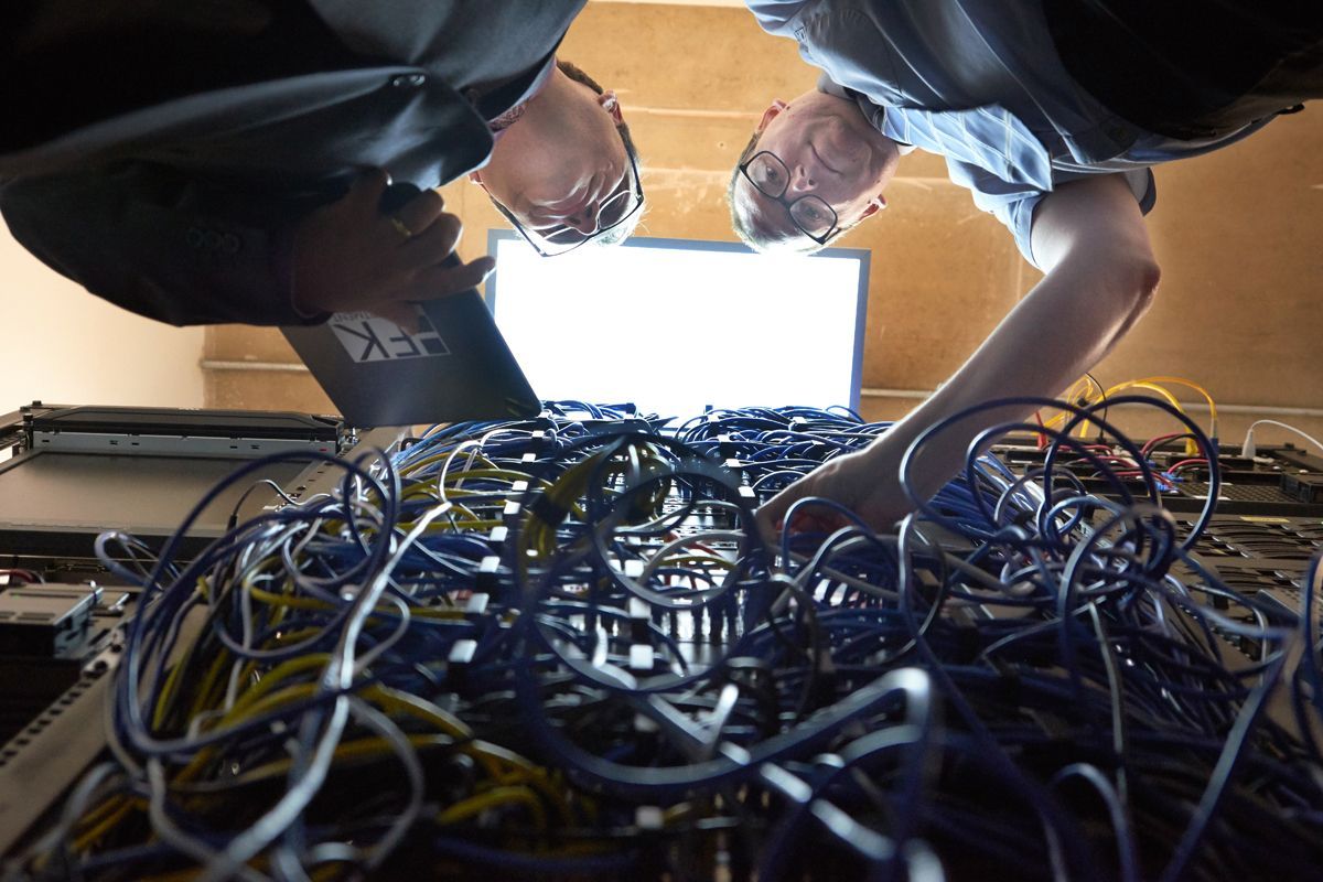 Foxley Kingham Chartered Accountants staff looking at full fibre network connections at their Luton office — corporate branding photography by Oakley Studios