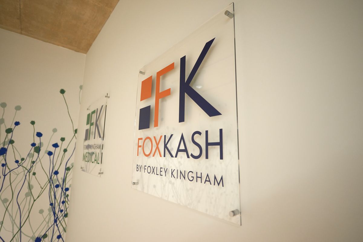Foxley Kingham Chartered Accountants logo on office wall — corporate branding photography by Oakley Studios, Luton