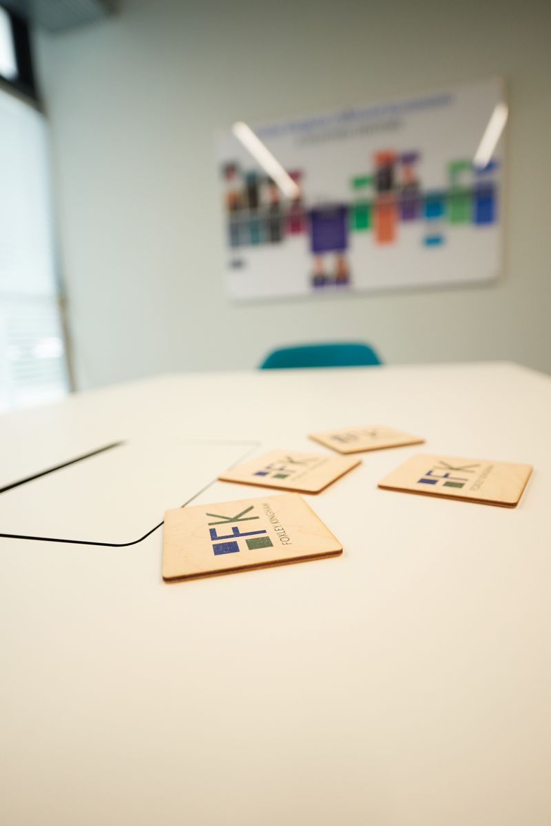Foxley Kingham business coasters on a meeting table — corporate branding photography by Oakley Studios, Luton and Bedfordshire
