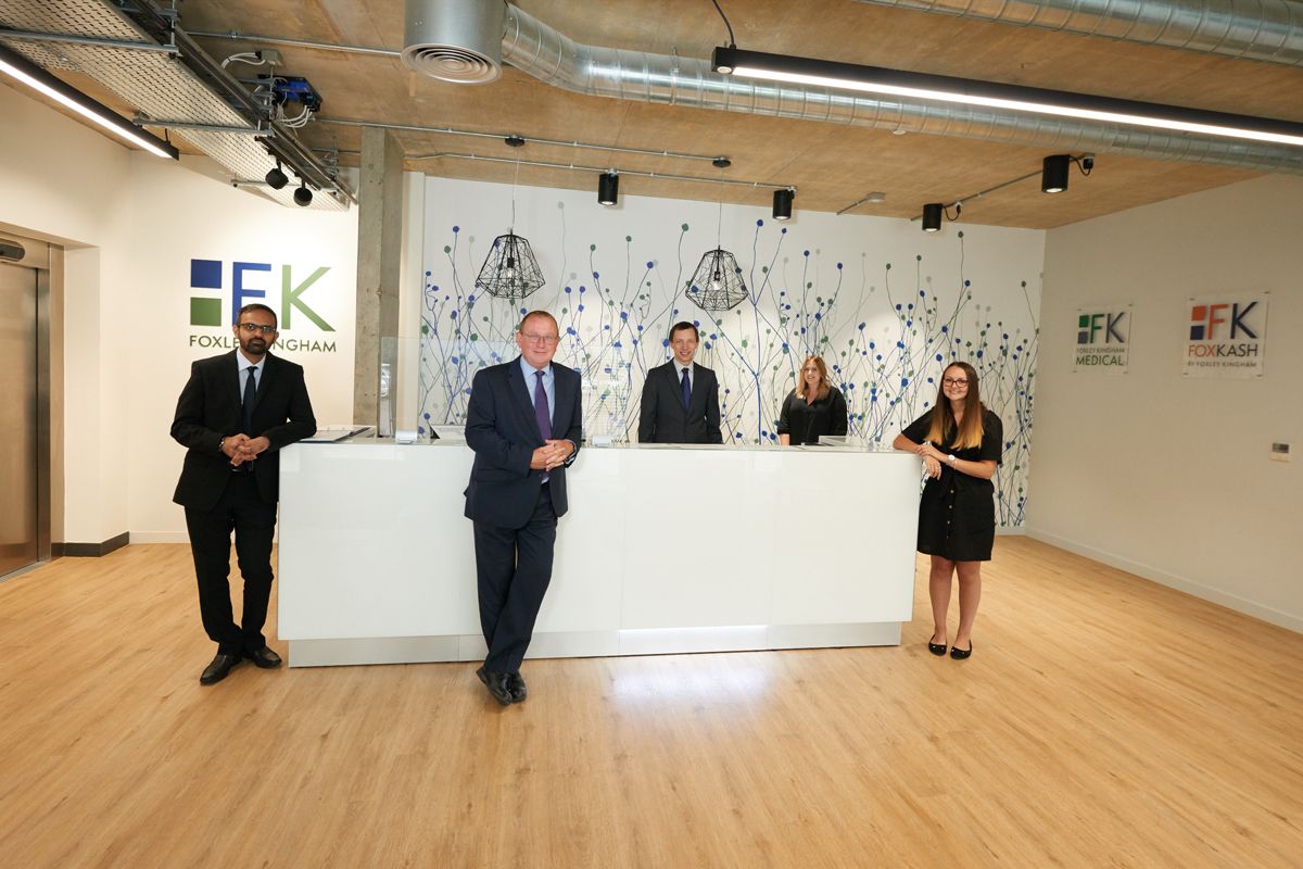 Foxley Kingham team at the reception desk — office branding photography by Oakley Studios, Luton and Bedfordshire