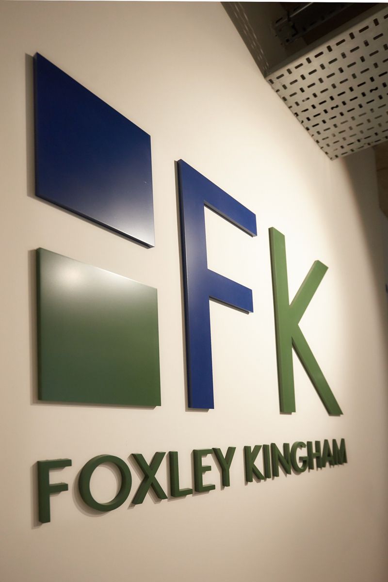 Foxley Kingham Chartered Accountants logo on office wall — corporate branding photography by Oakley Studios, Luton