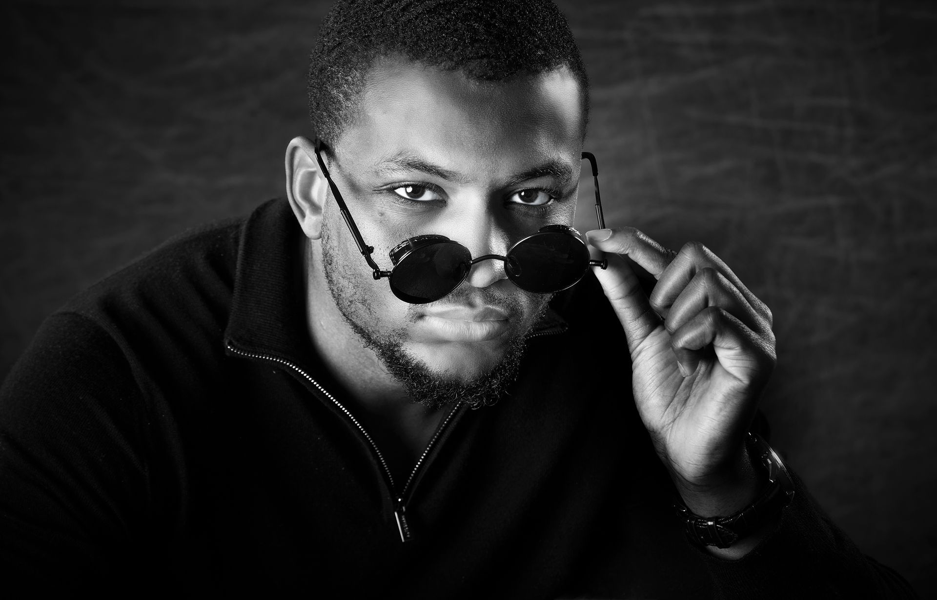 Young man in sunglasses posing for a solo portrait session at Oakley Studios, Luton and Bedfordshire