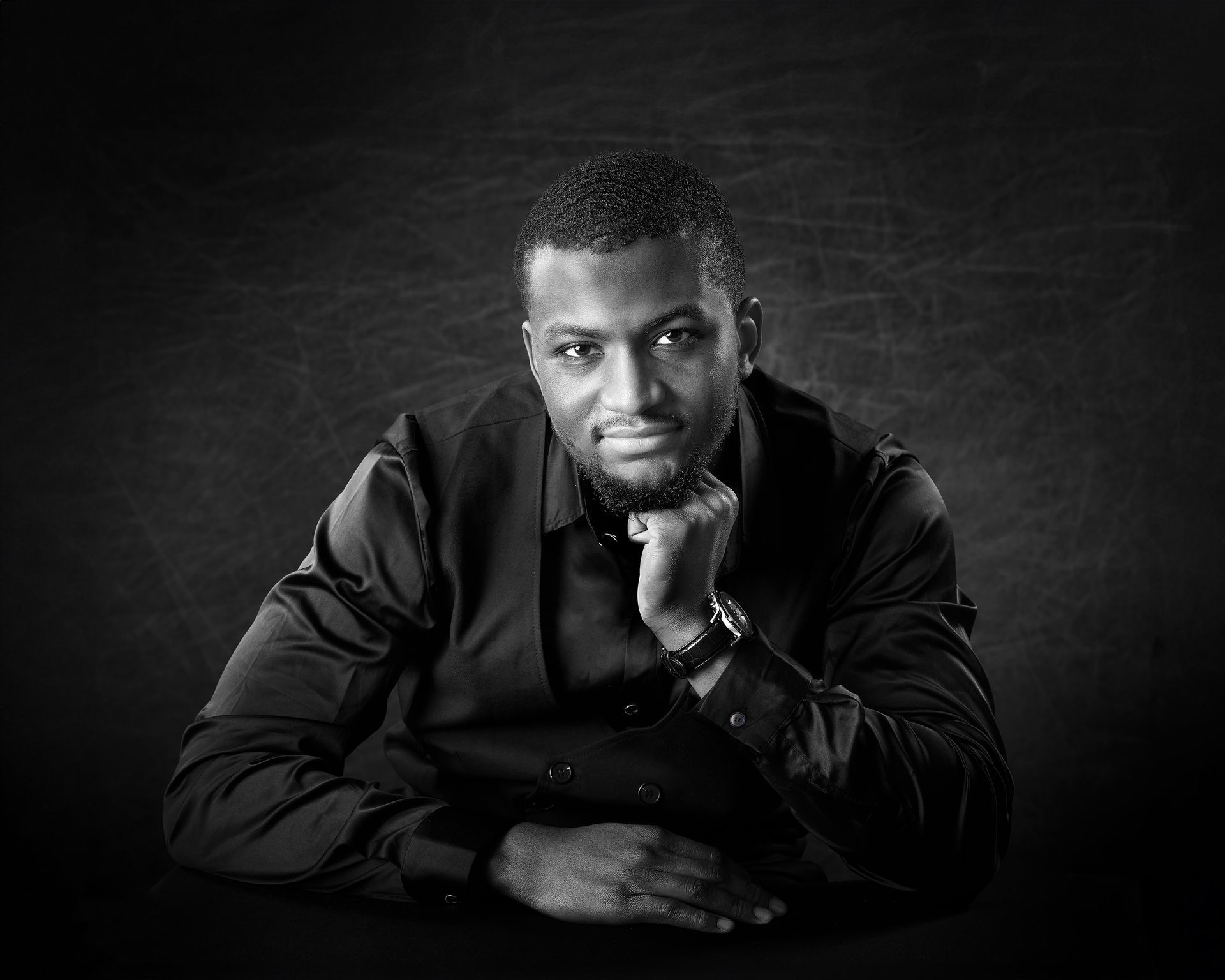 Black and white professional headshot of a man with hand on chin — Oakley Studios business photography, Luton