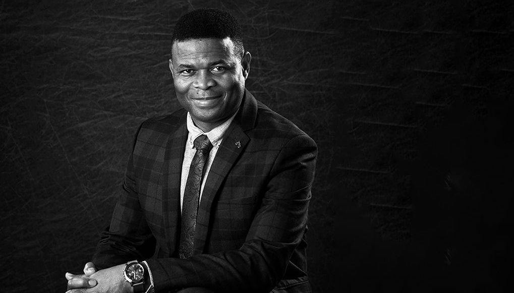 Professional business headshot of a smiling man in a suit at Oakley Studios, Bedfordshire