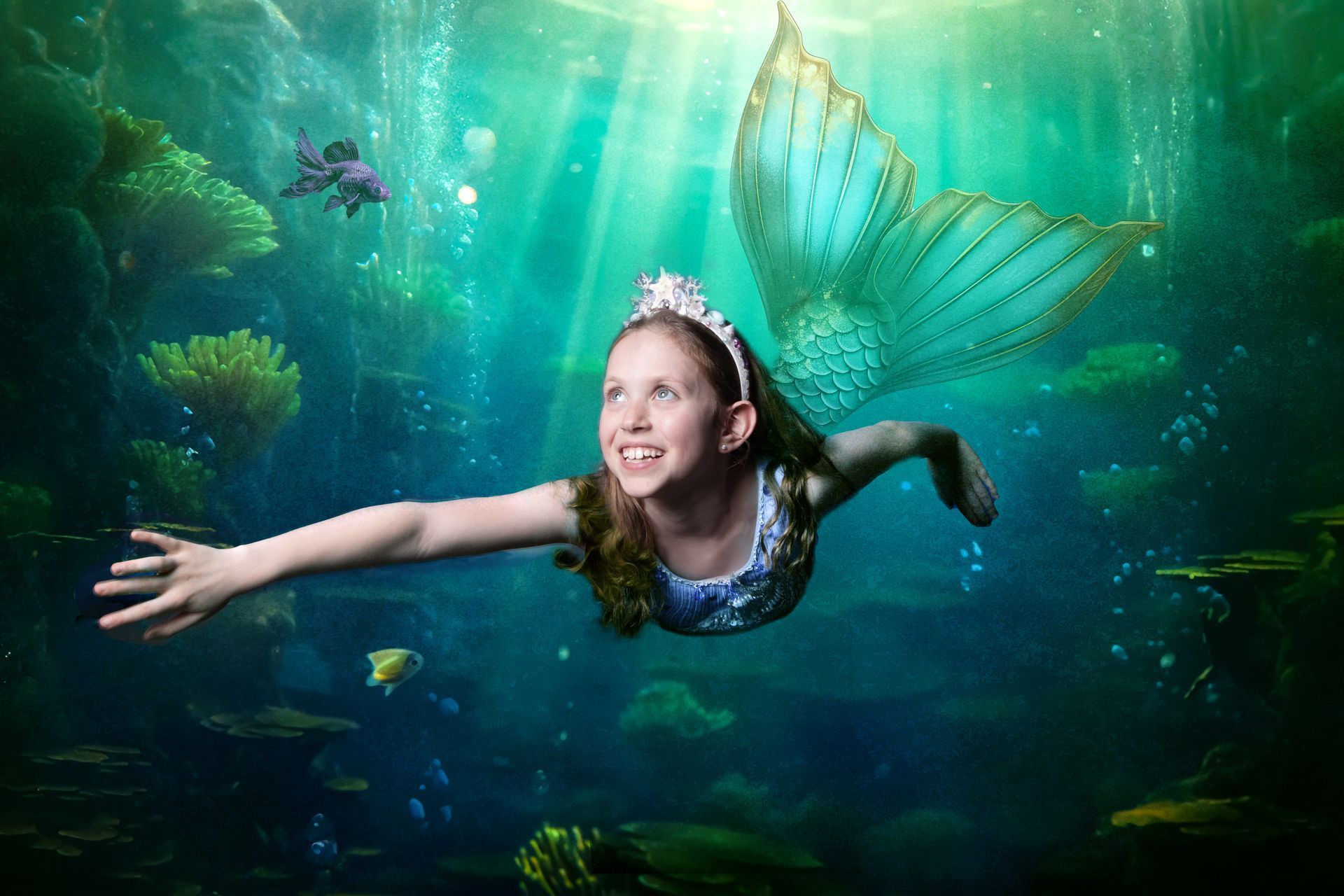 Child in a mermaid costume swimming during the Mermaids and Unicorns fantasy photoshoot at Oakley Studios, Luton and Dunstable border