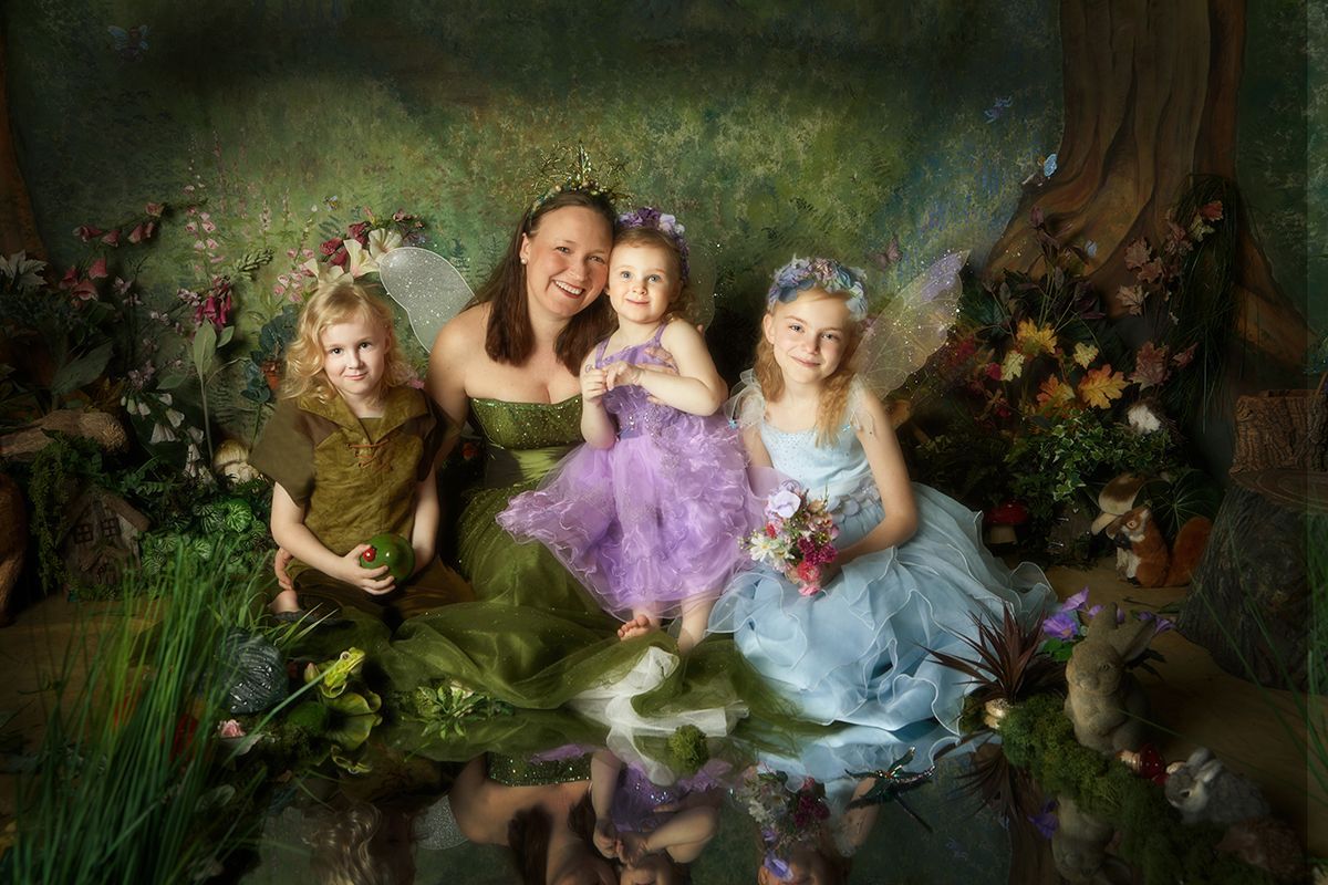 After — mum and three daughters as finished fairy portraits with hand-applied magic effects by Oakley Studios, Luton