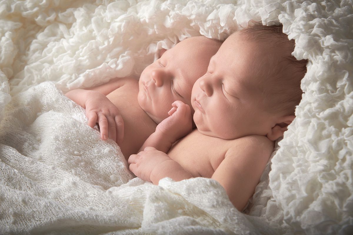 Newborn twins after professional retouching at Oakley Studios — hand-finished newborn portrait editing, Luton