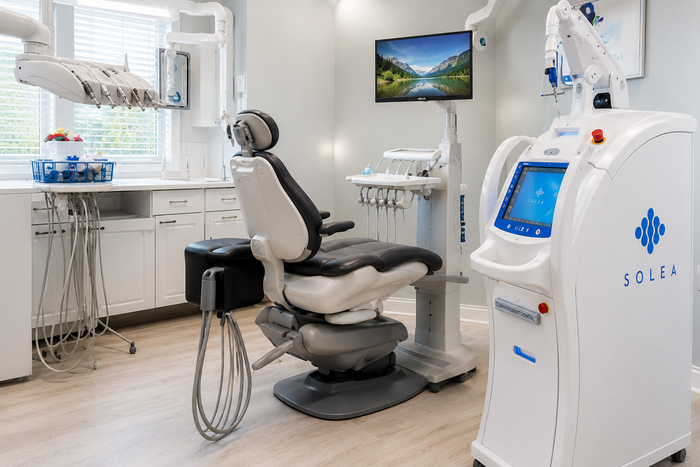 Modern dental office with exam chair, overhead light, and medical equipment
