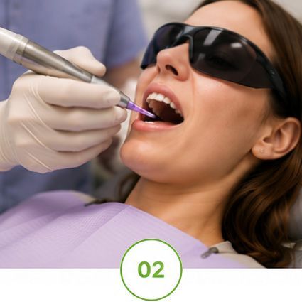 Dentist using a drill on a patient wearing dark protective glasses