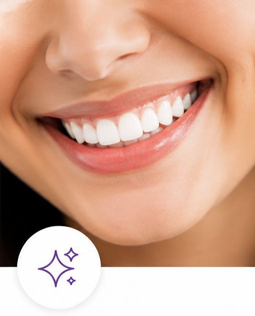 Close-up of a smiling mouth with bright white teeth and glossy pink lips