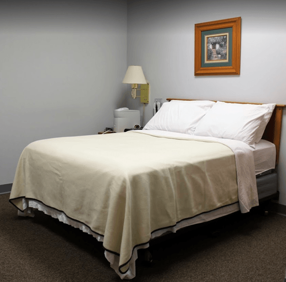 A bed in a sleep clinic room