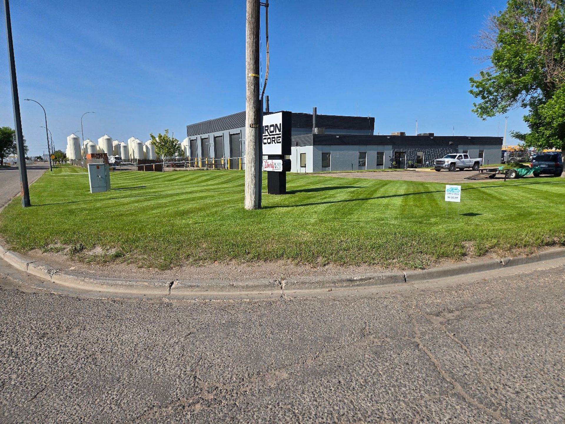 Commercial building with green lawn.