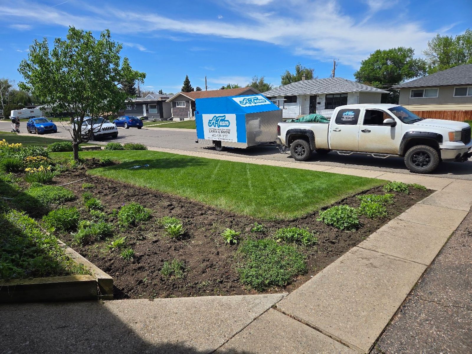 A front yard with a lawn and garden bed.