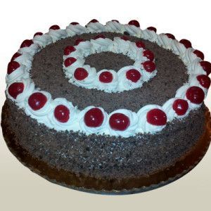 Black Forest cake with white frosting and cherries.