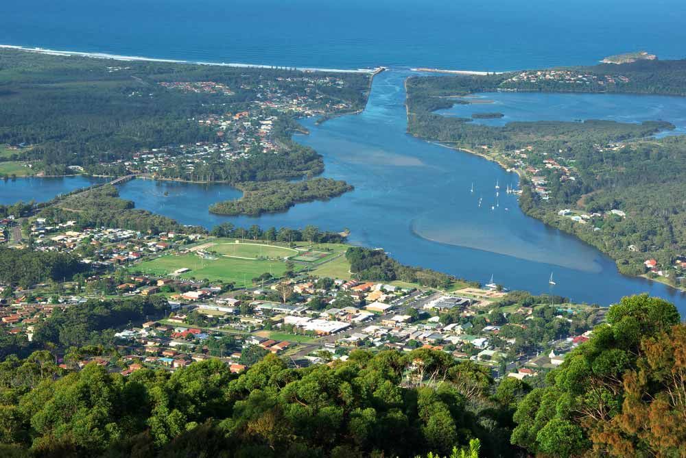 An Aerial View Of A River Flowing Through A Small Town — Triple S Scaffolding In Laurieton, NSW