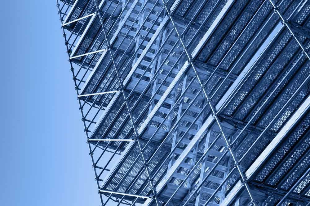 A Building Under Construction With Scaffolding On It Against A Blue Sky — Triple S Scaffolding In Laurieton, NSW