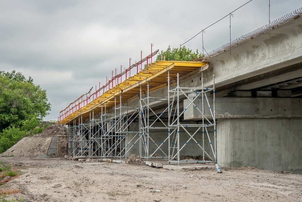 A Bridge Under Construction With Scaffolding On The Side Of It — Triple S Scaffolding In South West Rocks, NSW