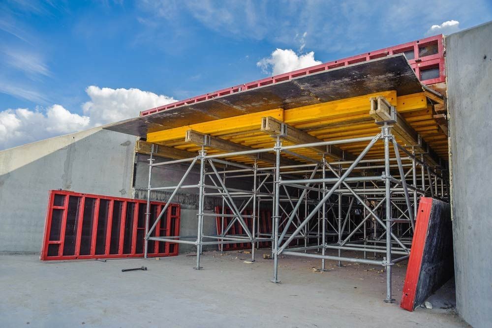 A Building Under Construction With Scaffolding And A Blue Sky In The Background — Triple S Scaffolding In South West Rocks, NSW