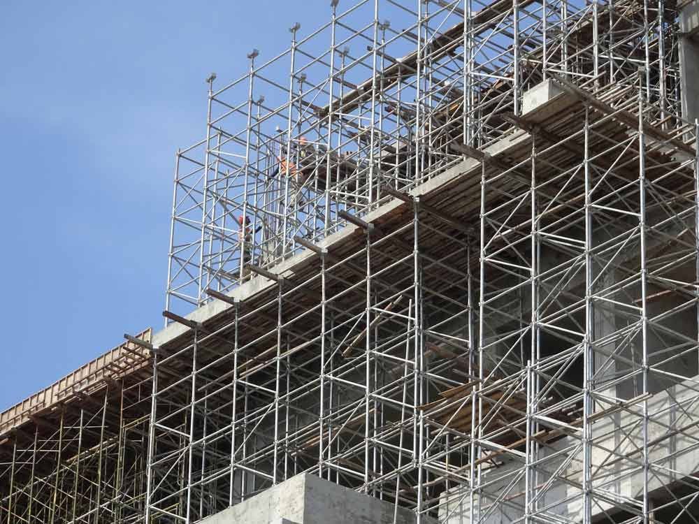 A Building Under Construction With Scaffolding On The Side Of It — Triple S Scaffolding In Forster, NSW