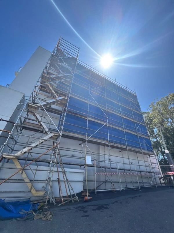 Red scaffolding at a building site— Triple S Scaffolding In Port Macquarie, NSW