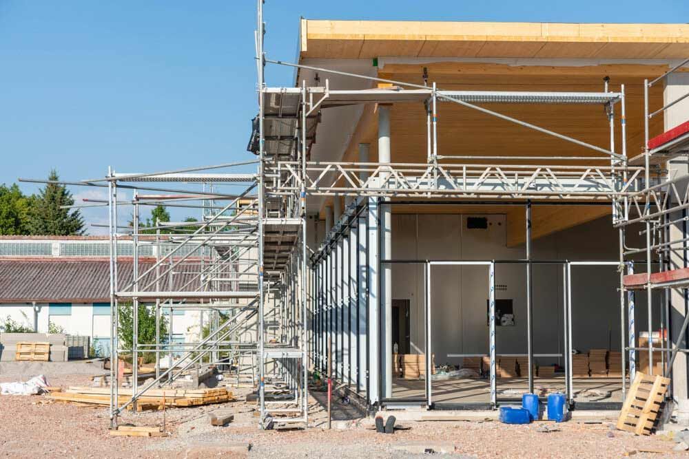 A Building Is Being Built With Scaffolding Around It — Triple S Scaffolding In Forster, NSW