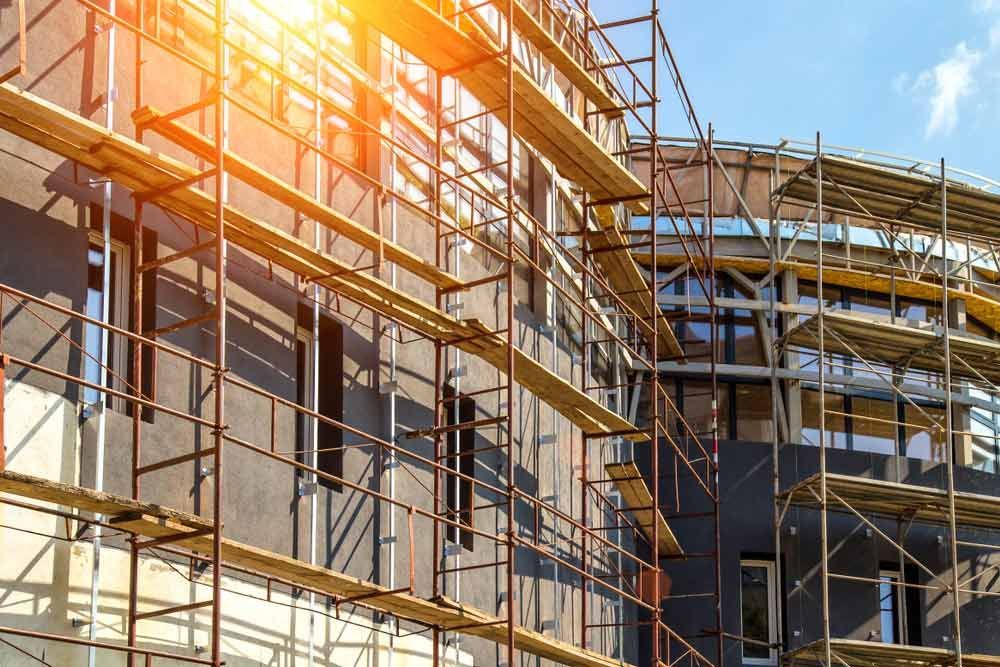 A Building Is Being Built With Scaffolding Around It — Triple S Scaffolding In Port Macquarie, NSW