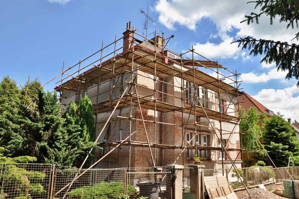 A House Is Being Remodelled With Scaffolding Around It — Triple S Scaffolding In South West Rocks, NSW