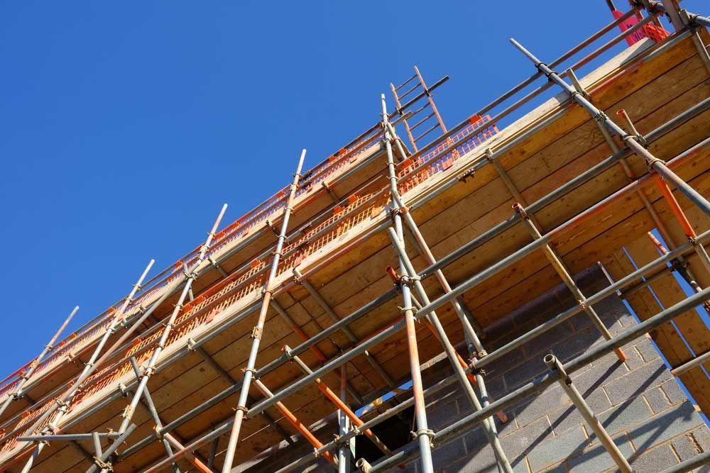 A Building Under Construction With Scaffolding And A Blue Sky In The Background — Triple S Scaffolding In South West Rocks, NSW