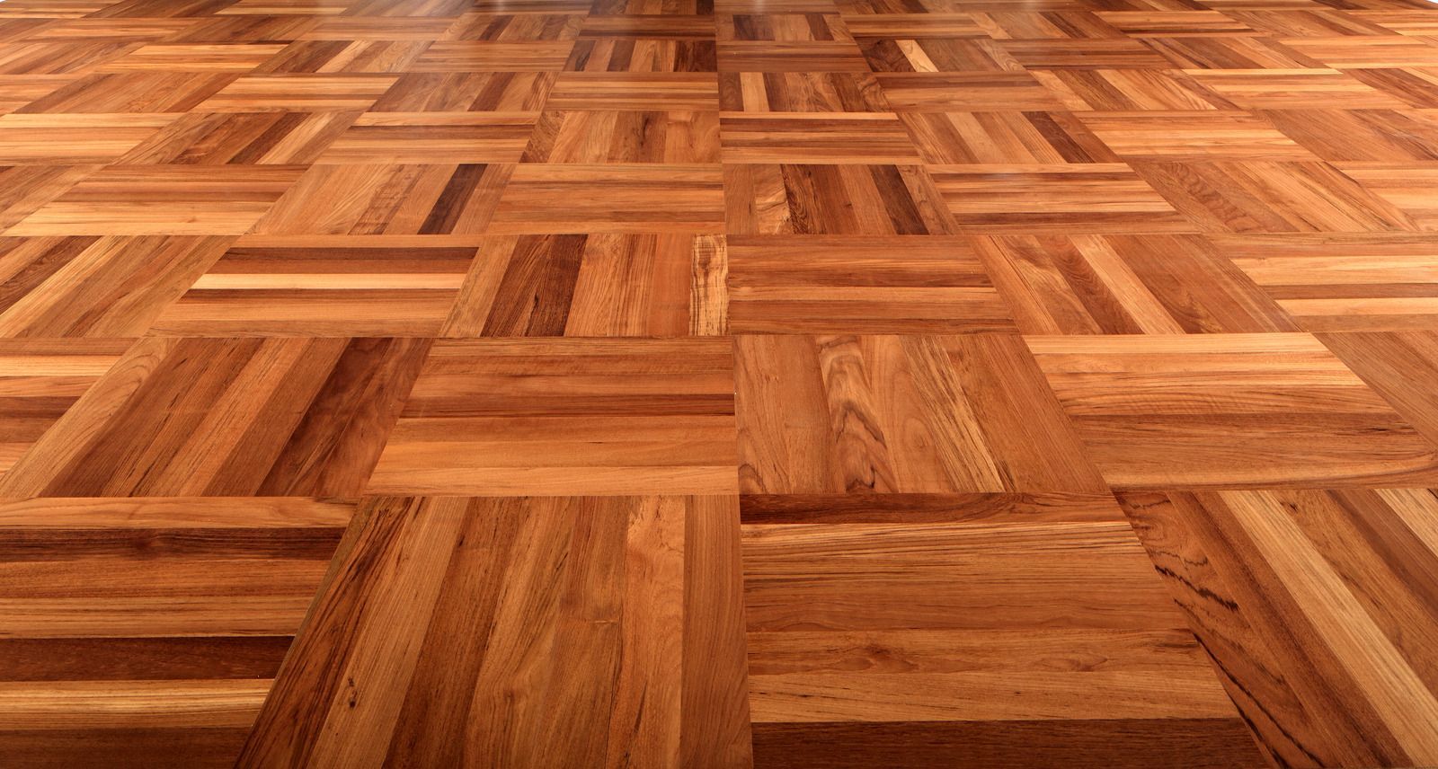 Close-up of a warm-toned parquet wood floor with a geometric block pattern