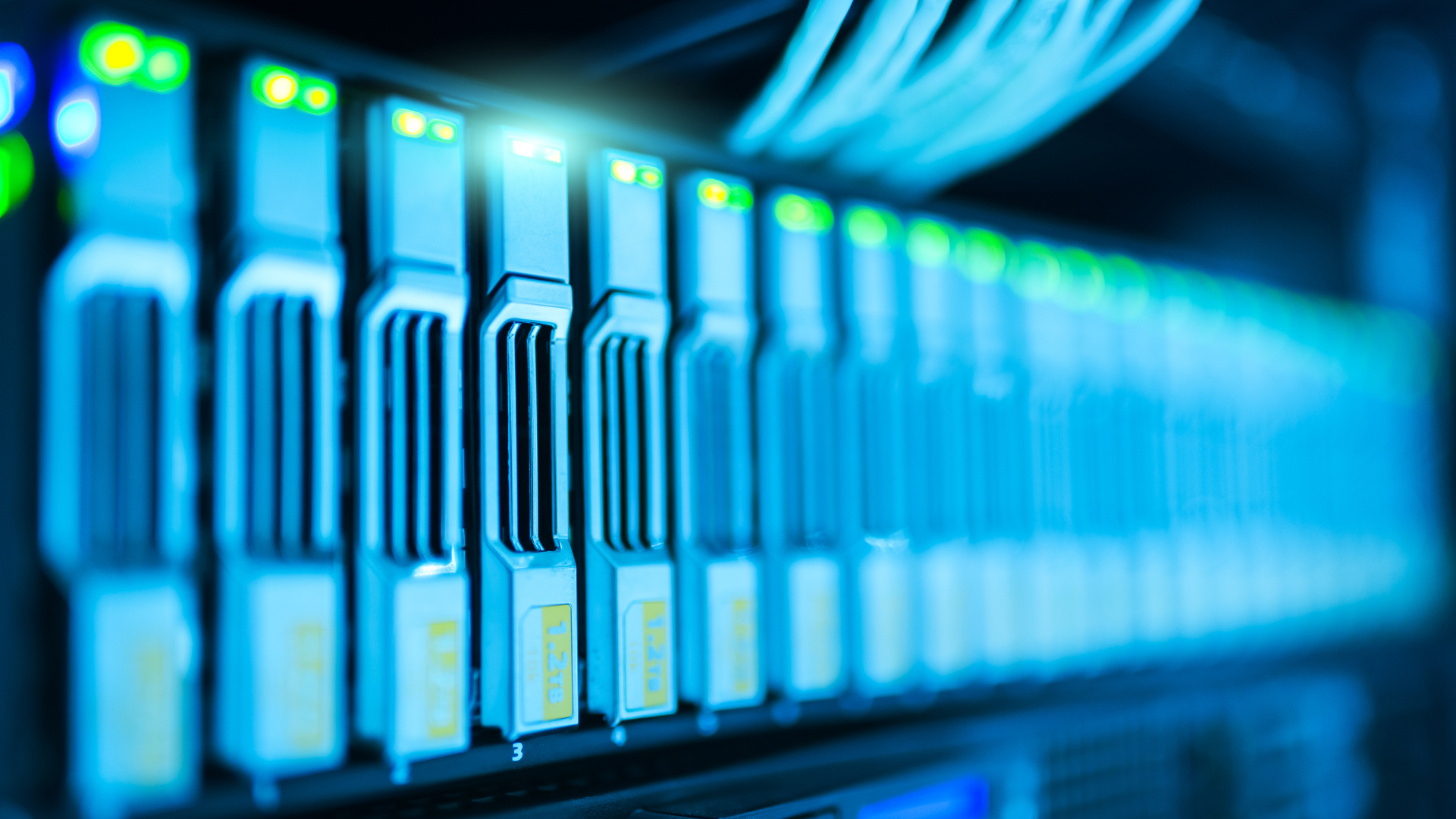 Server rack with rows of interconnected hardware, glowing blue lights.