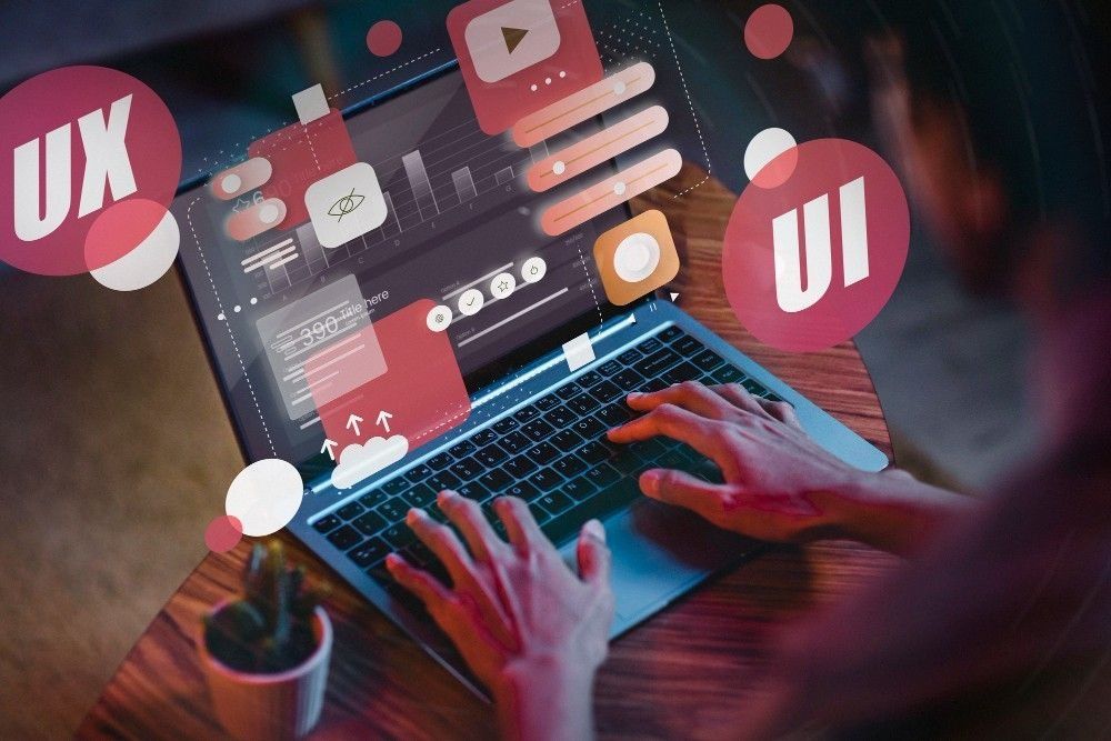 Person using a laptop, overlaid with UI/UX design elements and labels.