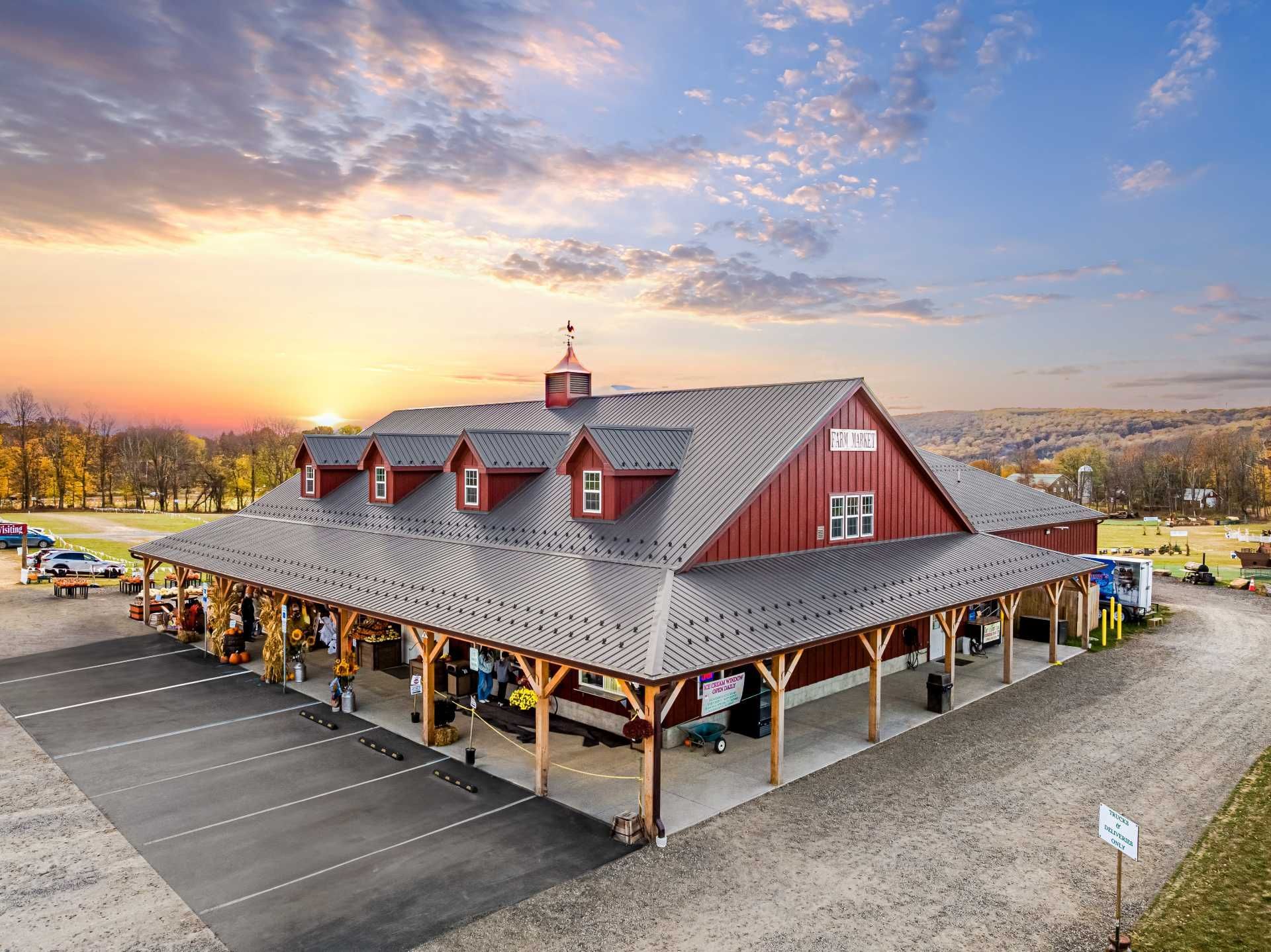 An aerial view of Bullhide Brewery in Pilesgrove, NJ, showing the parking lot, front facade, and roof of the structure.