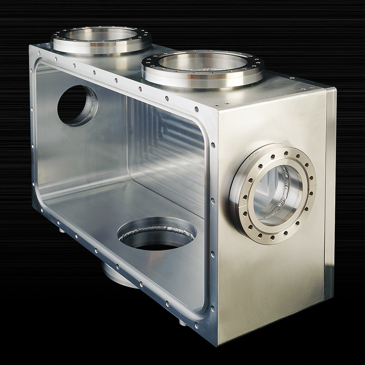 Custom aluminum x-ray mirror-mount chamber with bimetal flanges on black background, used for synchrotron applications.