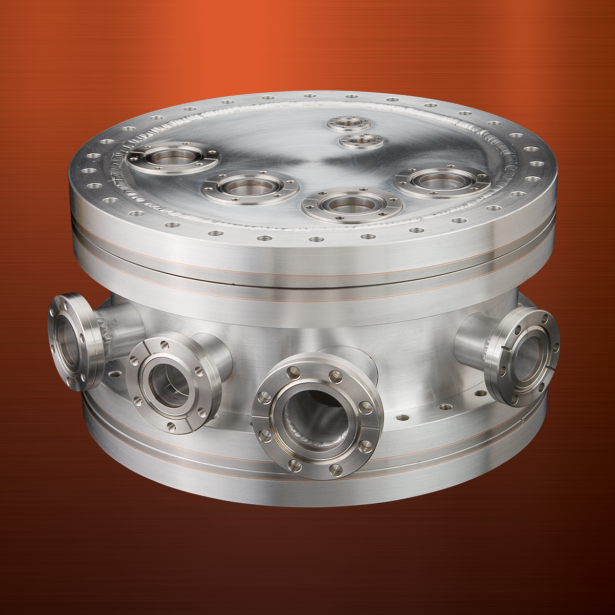 A cylindrical aluminum UHV chamber with bimetal ConFlat flush mount and weld neck flanges 1.33 to 4.5”, on orange background.