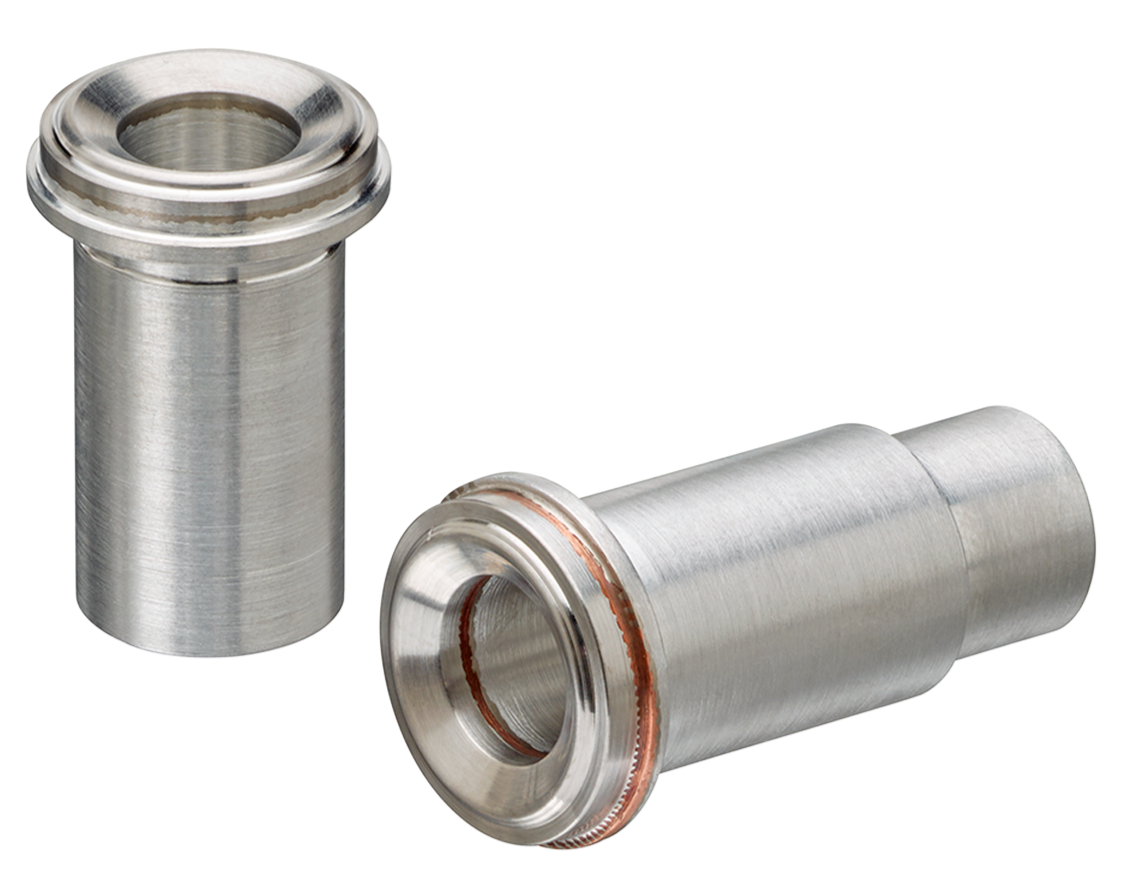 Two bimetal aluminum-stainless Face Seal Fittings (ATCRs) sitting next to each other on a white surface.