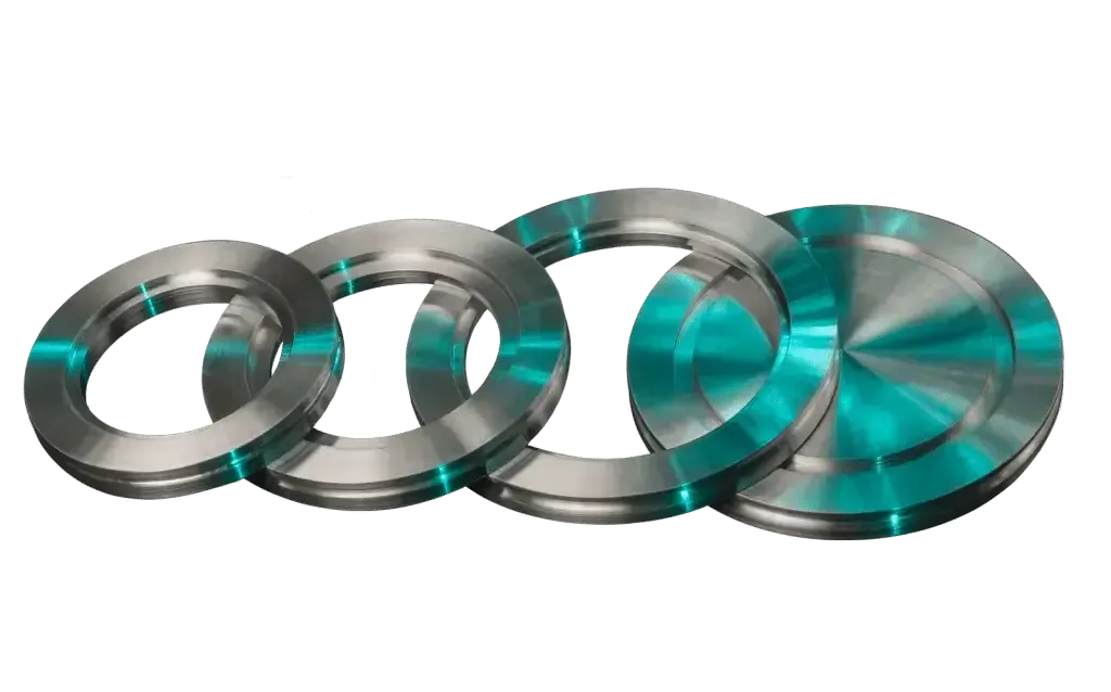 An assortment of circular high vacuum (HV) compatible ISO flanges, some blank and some with bore, shown in turquoise light.