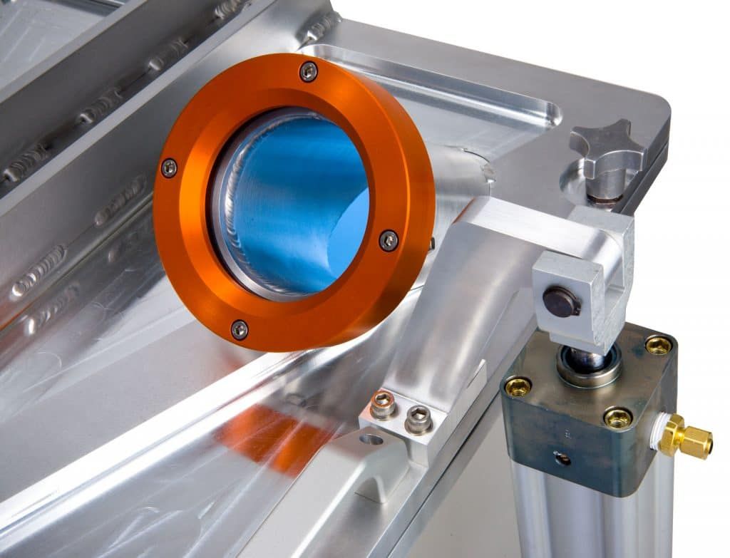 Close up of aluminum vacuum chamber with anodized optical port and weight reducing lightening pockets and stiffeners.