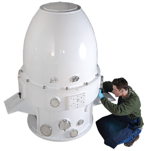 A 7-foot tall white vacuum shroud for Smithsonian infrared telescope being inspected.