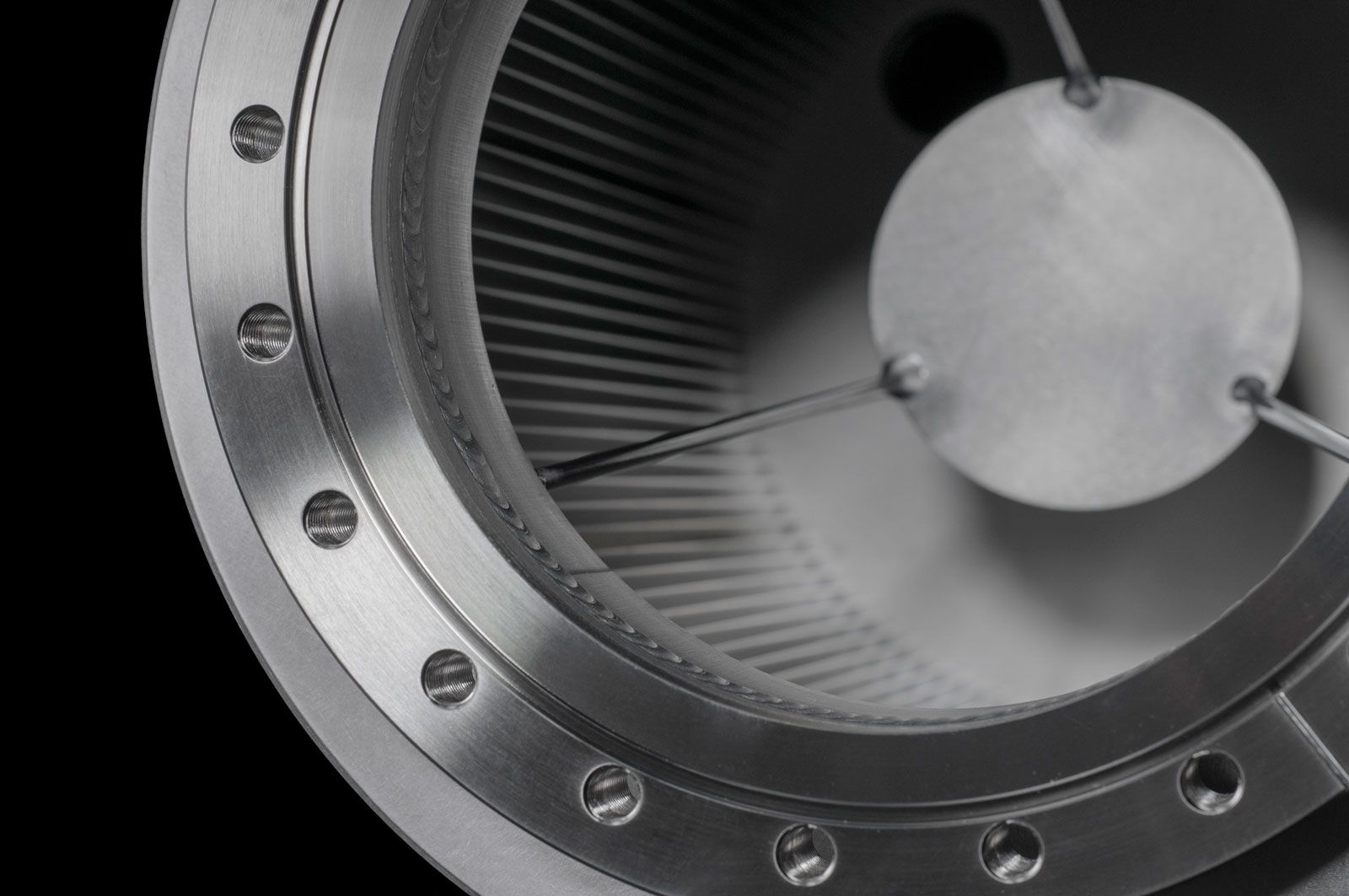 Close up of an aluminum housing with interior fins for UHV/XHV vacuum pumping via titanium sublimination.