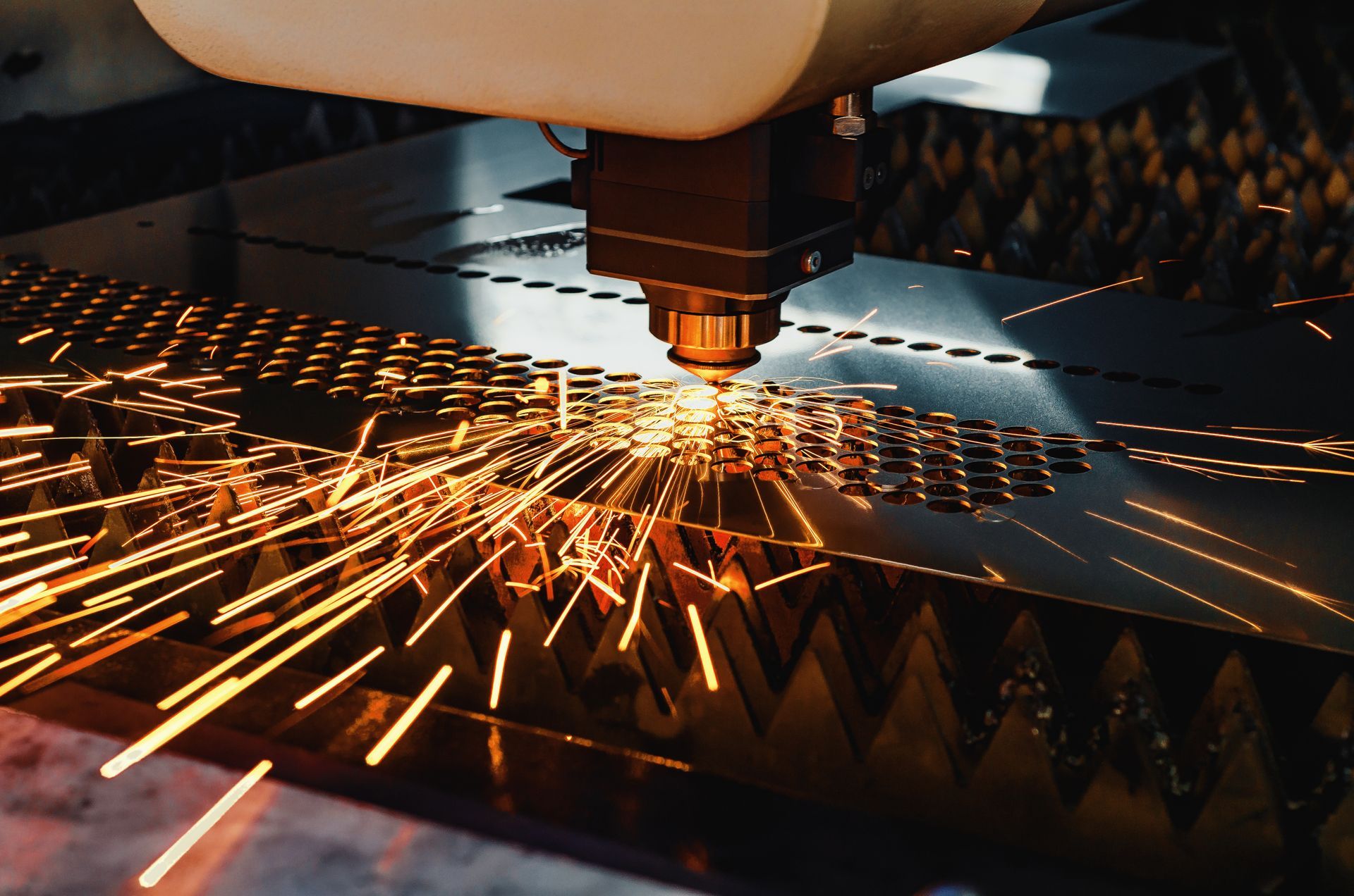 A close-up of a high-precision CNC laser cutting metal sheet.
