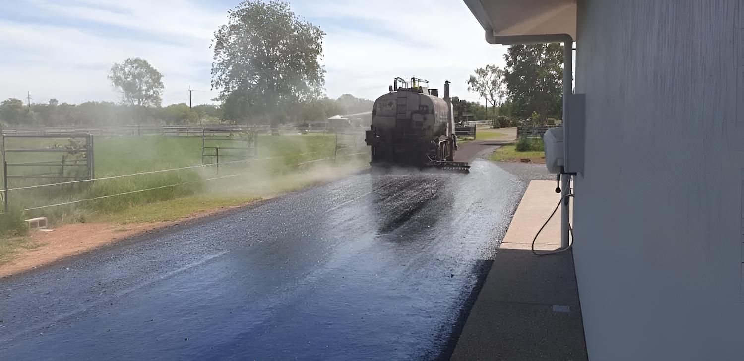 A Truck is Spraying Water on a Road — F & J Bitumen Services in Humpty Doo, NT