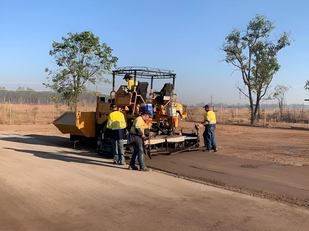 A Group of Construction Workers Are Working on a Road — F & J Bitumen Services in Humpty Doo, NT