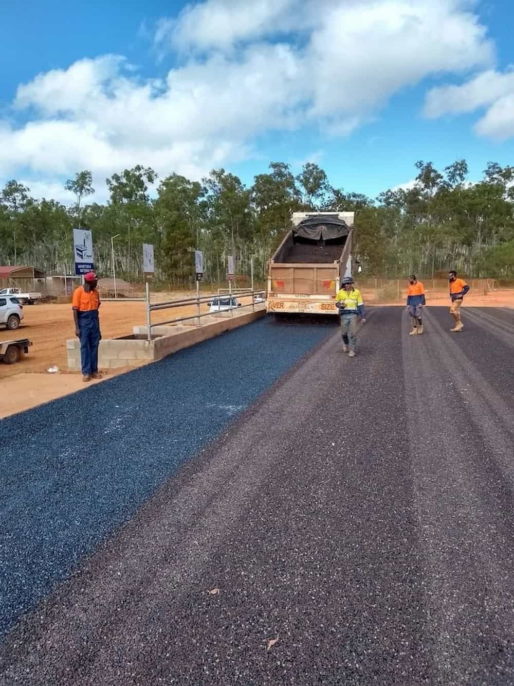A Dump Truck is Being Loaded With Gravel on a Dirt Road — F & J Bitumen Services in Humpty Doo, NT