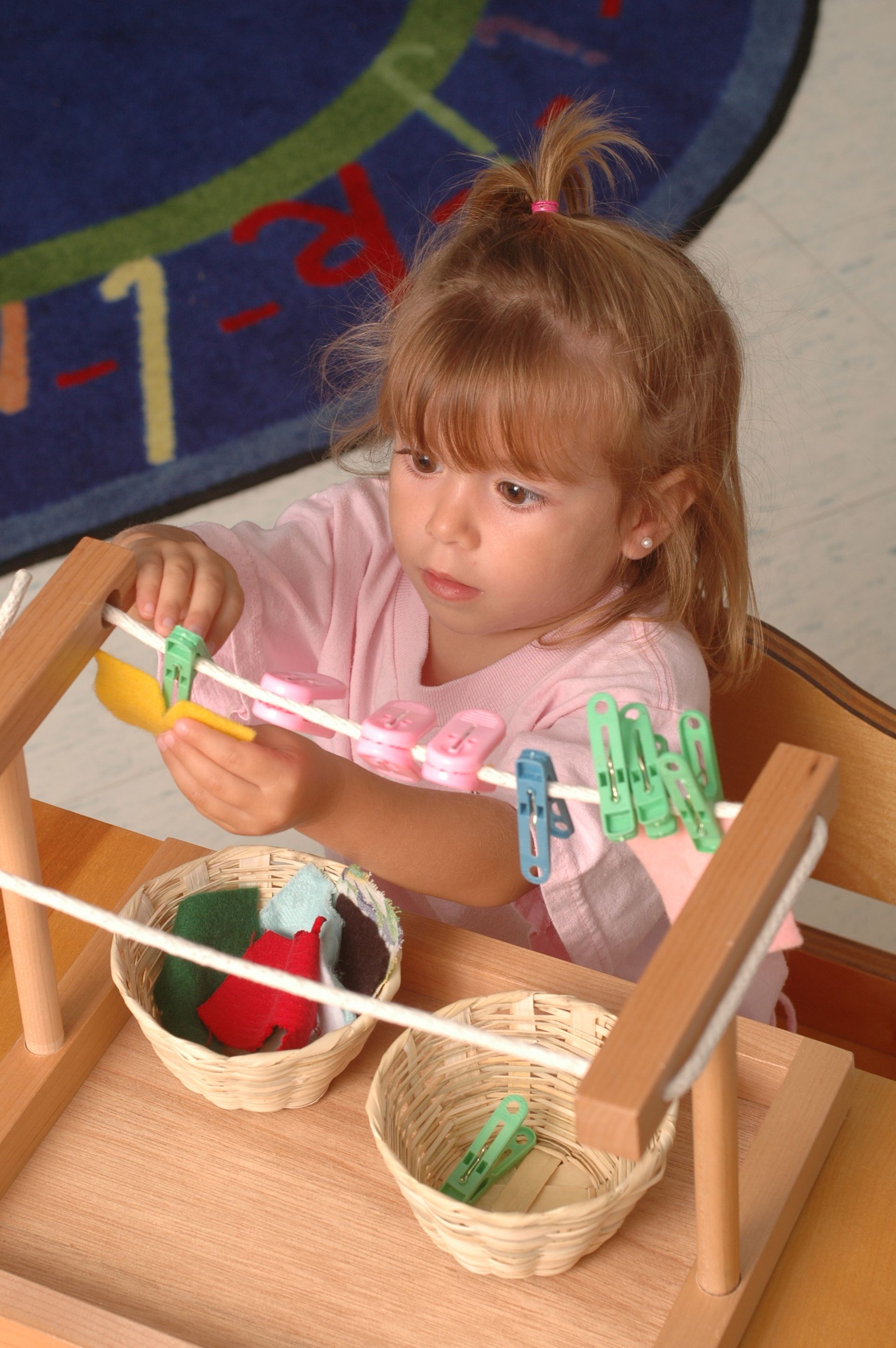 Montessori toddler working on a practical life activity