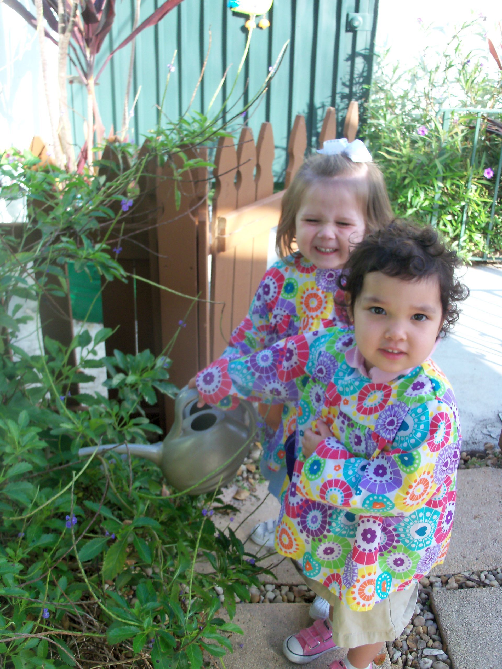 Montessori toddlers watering plants 