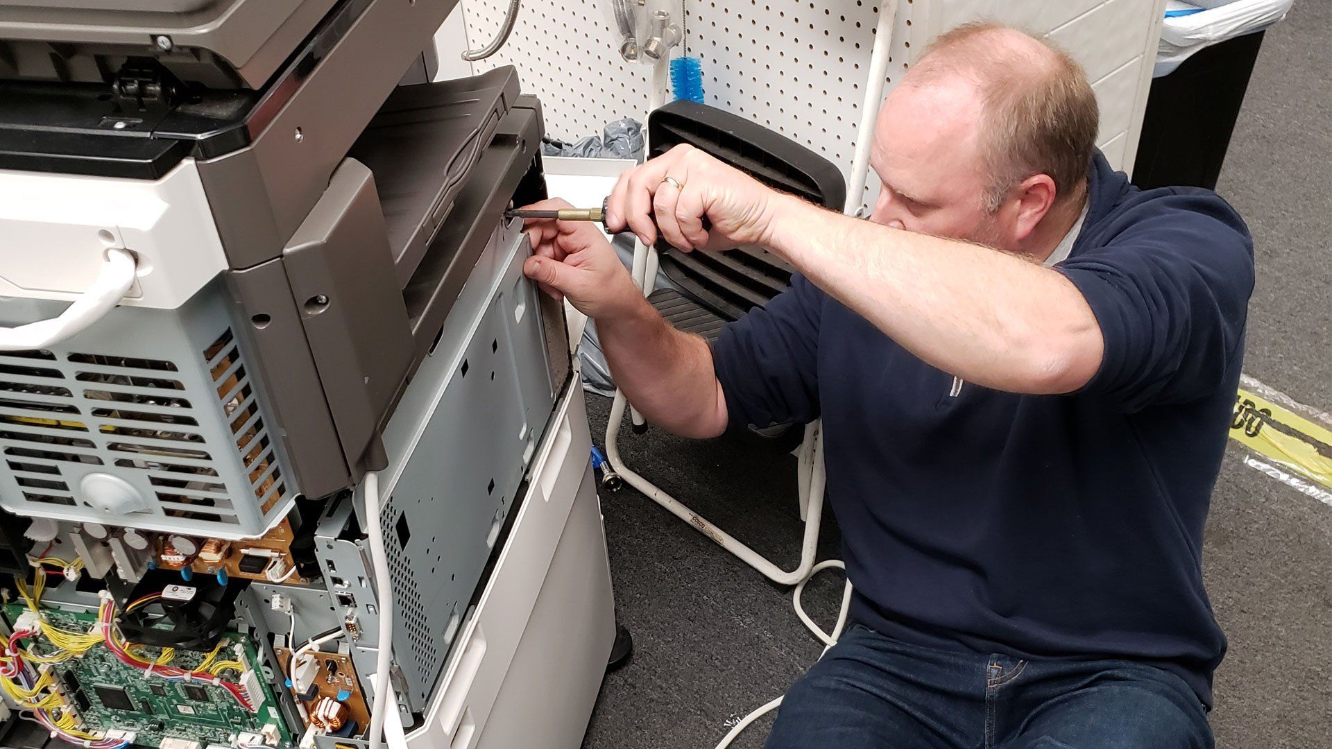 Printsmart technician fixing copiers