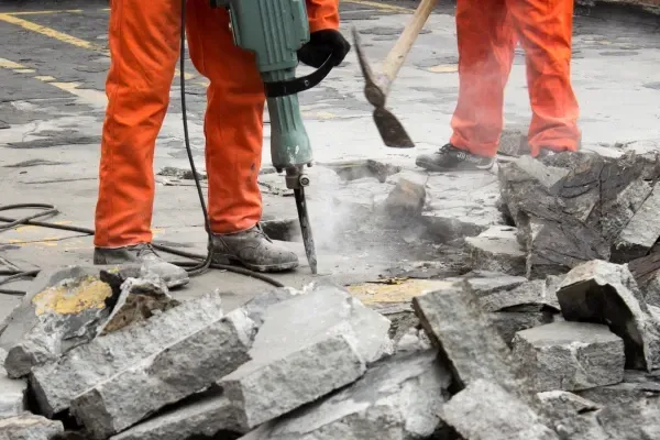 Removing damaged concrete from a property.