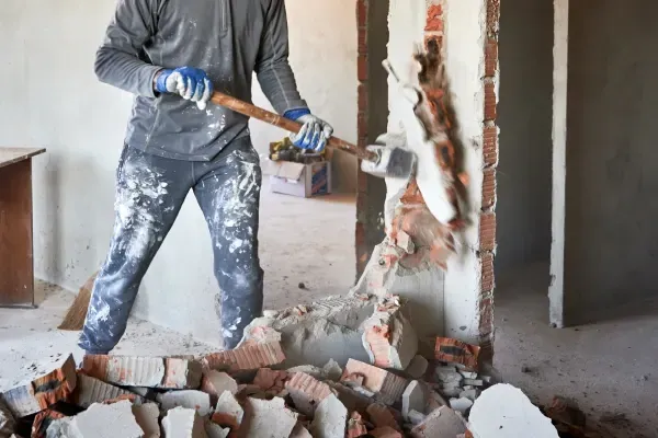 Removing interior walls and fixtures during renovation.