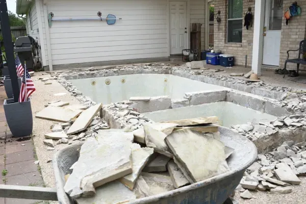 Breaking down and removing an old backyard pool.